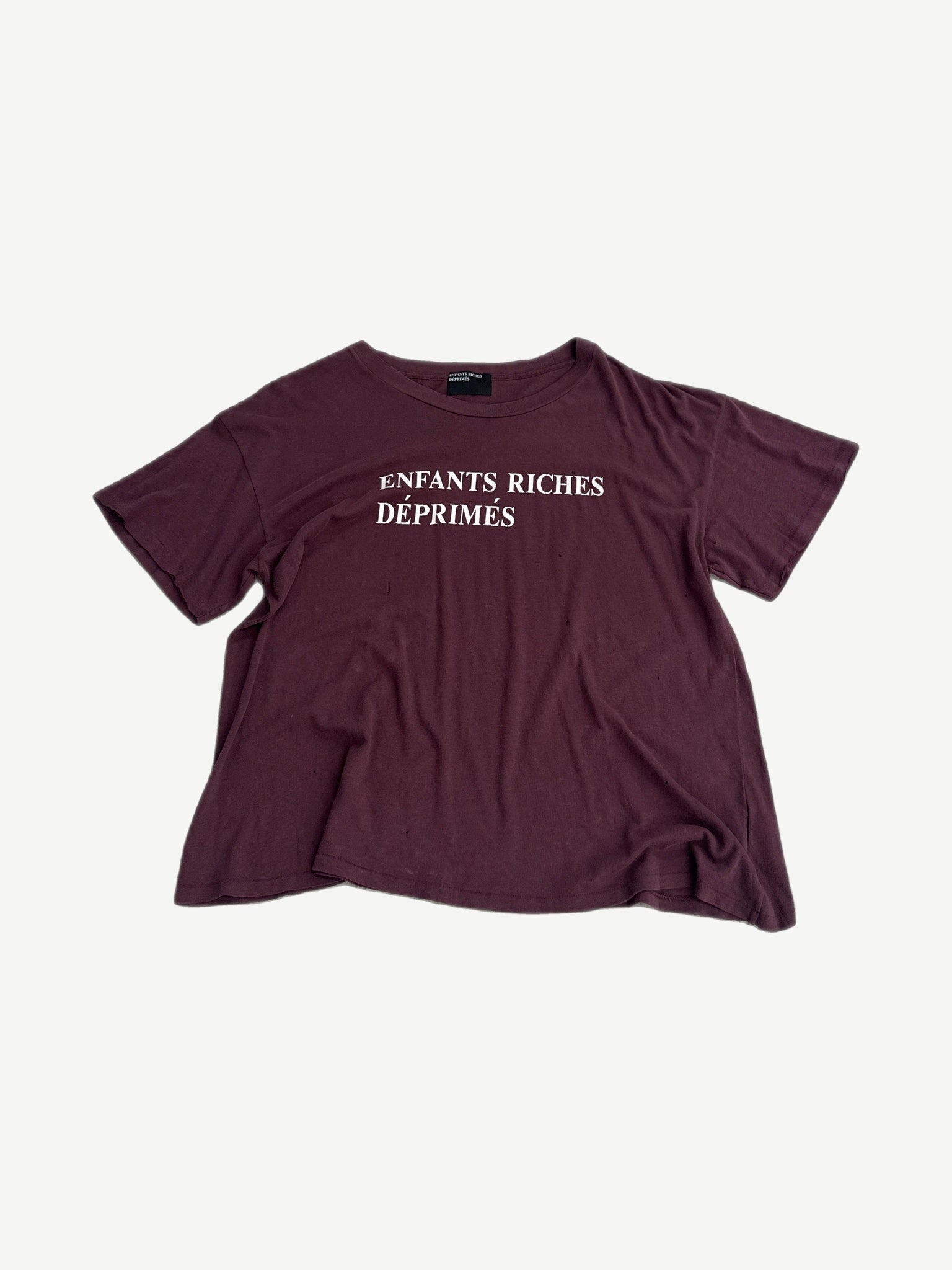 Enfants Riches Deprimes maroon cotton tee with white spray paint logo lettering printed across the chest.