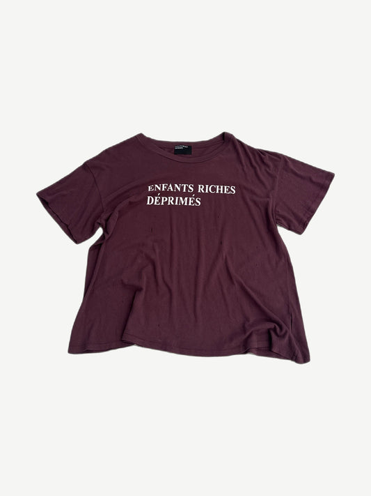 Enfants Riches Deprimes maroon cotton tee with white spray paint logo lettering printed across the chest.