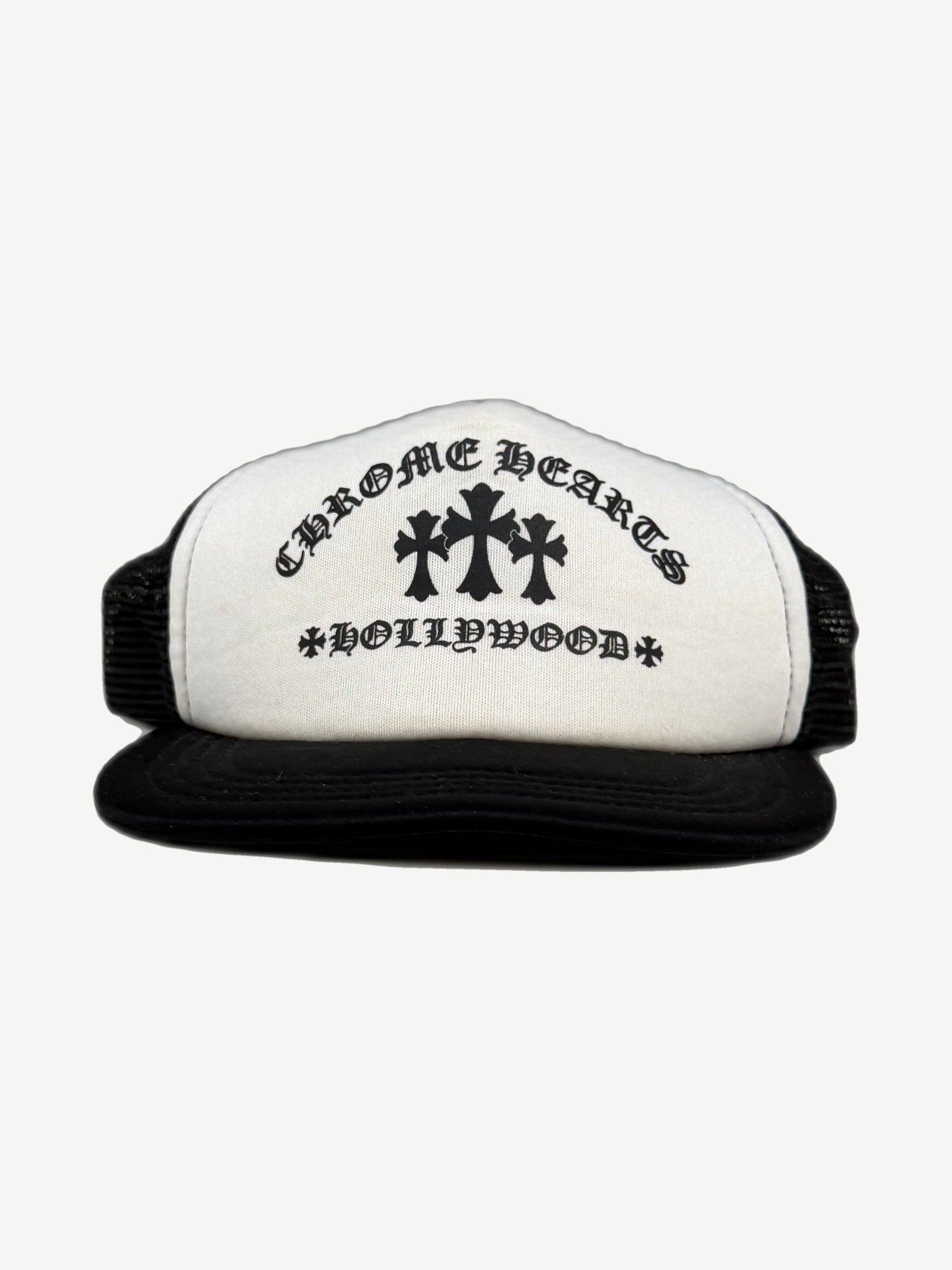 Chrome Hearts black and white trucker hat with Hollywood gothic logo and triple cross print on front.