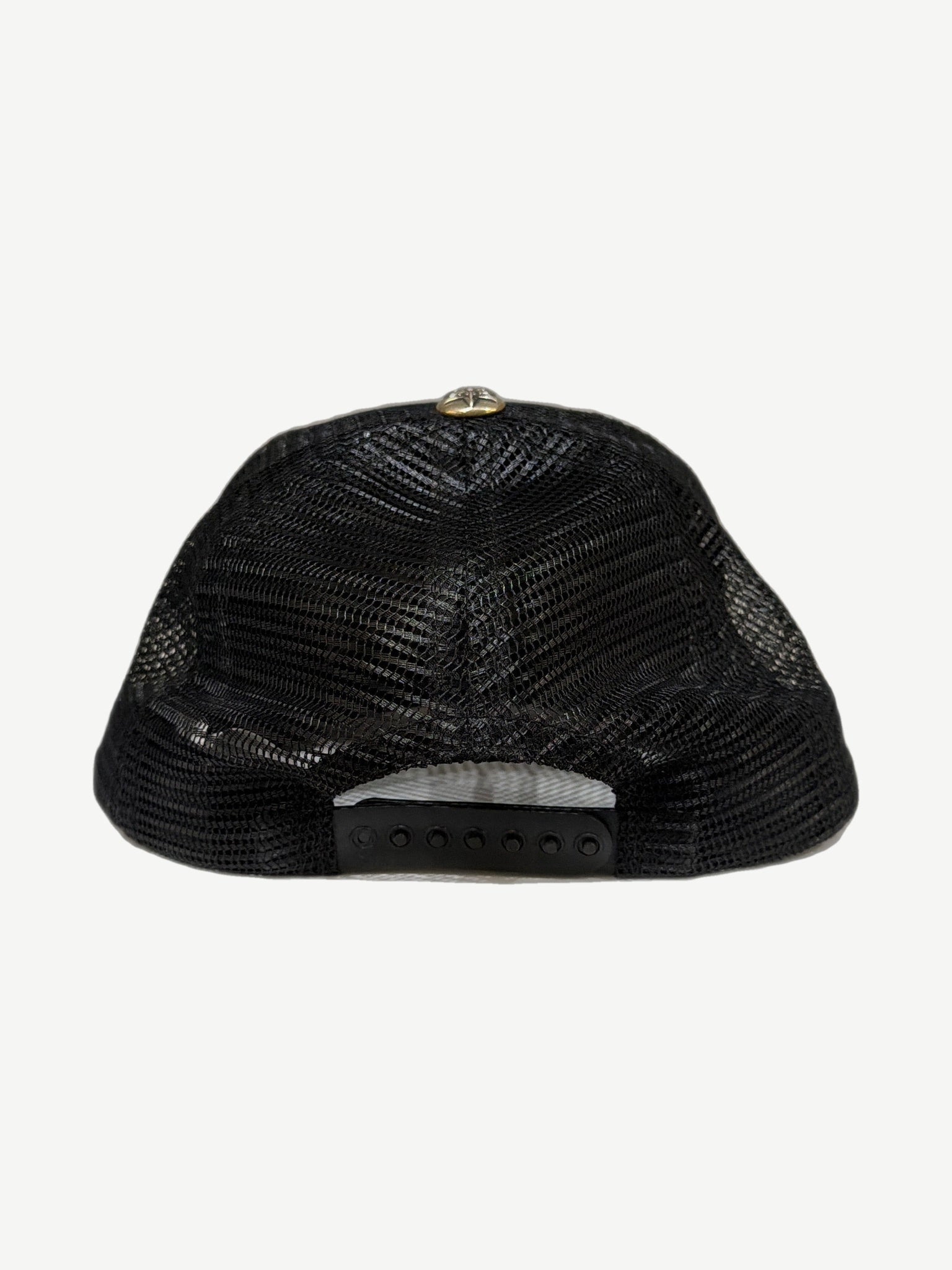 Chrome Hearts triple star trucker hat side profile showing curved brim and structured foam crown.