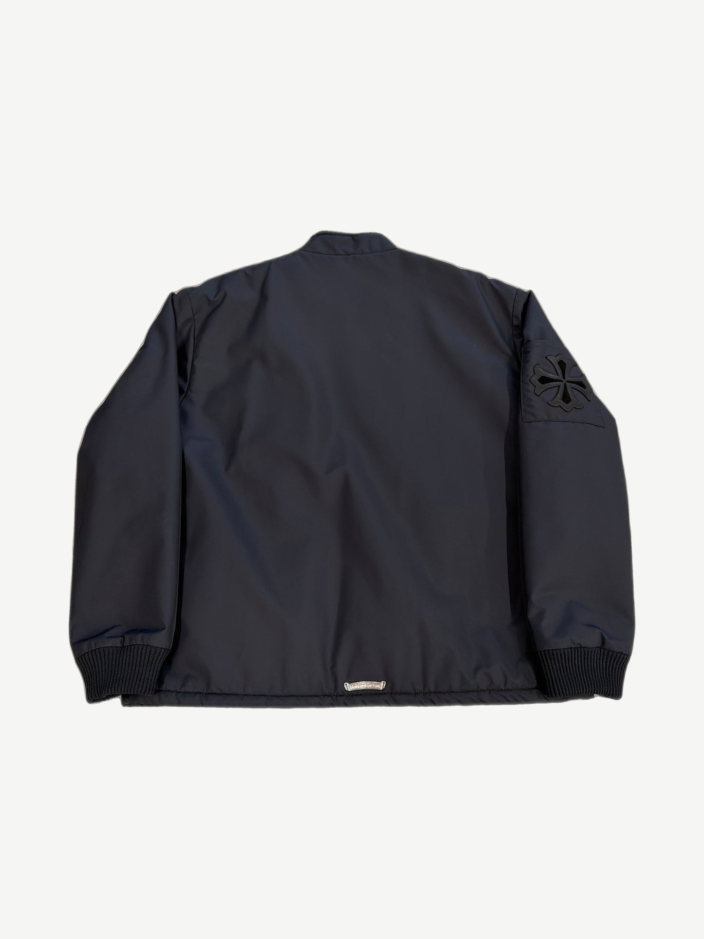 Chrome Hearts black Cobra racing jacket back view with black leather cross patch on right sleeve