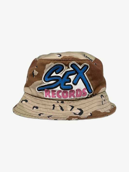 Chrome Hearts Matty Boy desert chocolate chip camo bucket hat front with blue SEX pink RECORDS leather patch
