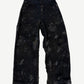 Balenciaga mud wash destroyed denim jeans with heavy distressing, shredded knees and faded brown earth tones.