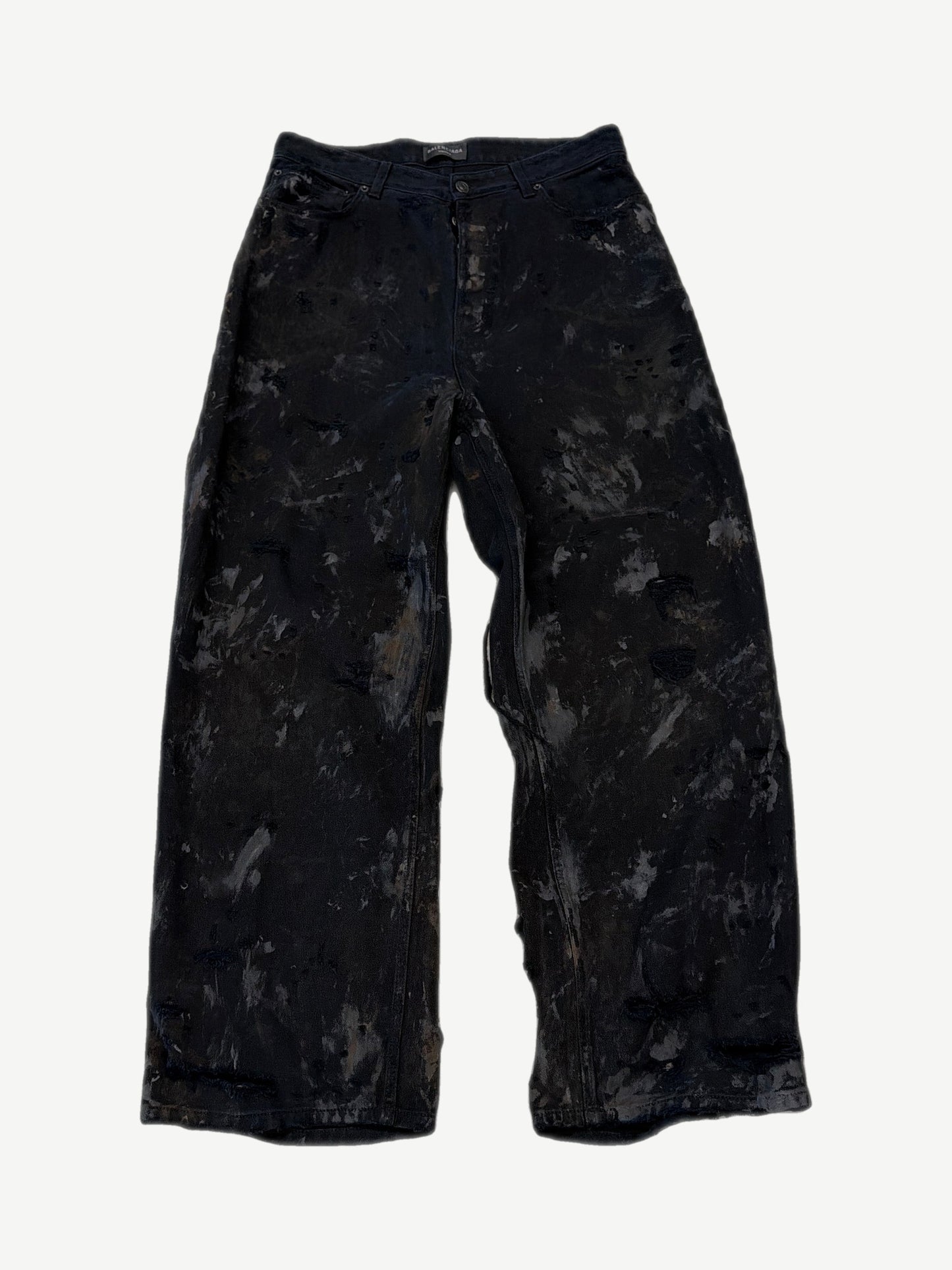 Balenciaga mud wash destroyed denim jeans with heavy distressing, shredded knees and faded brown earth tones.