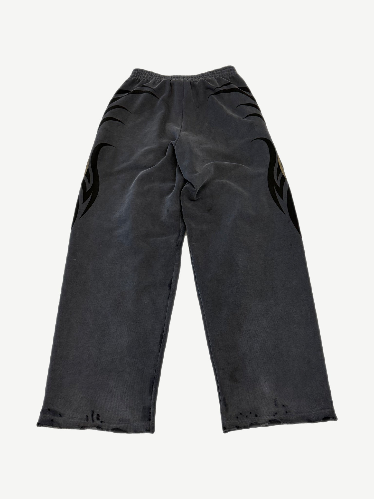 Balenciaga washed gray sweatpants with tacky gold tribal flame print across hips and distressed raw hems