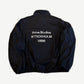 Back of Acne Studios navy nylon jacket with washed white Acne Studios Stockholm 1996 logo print