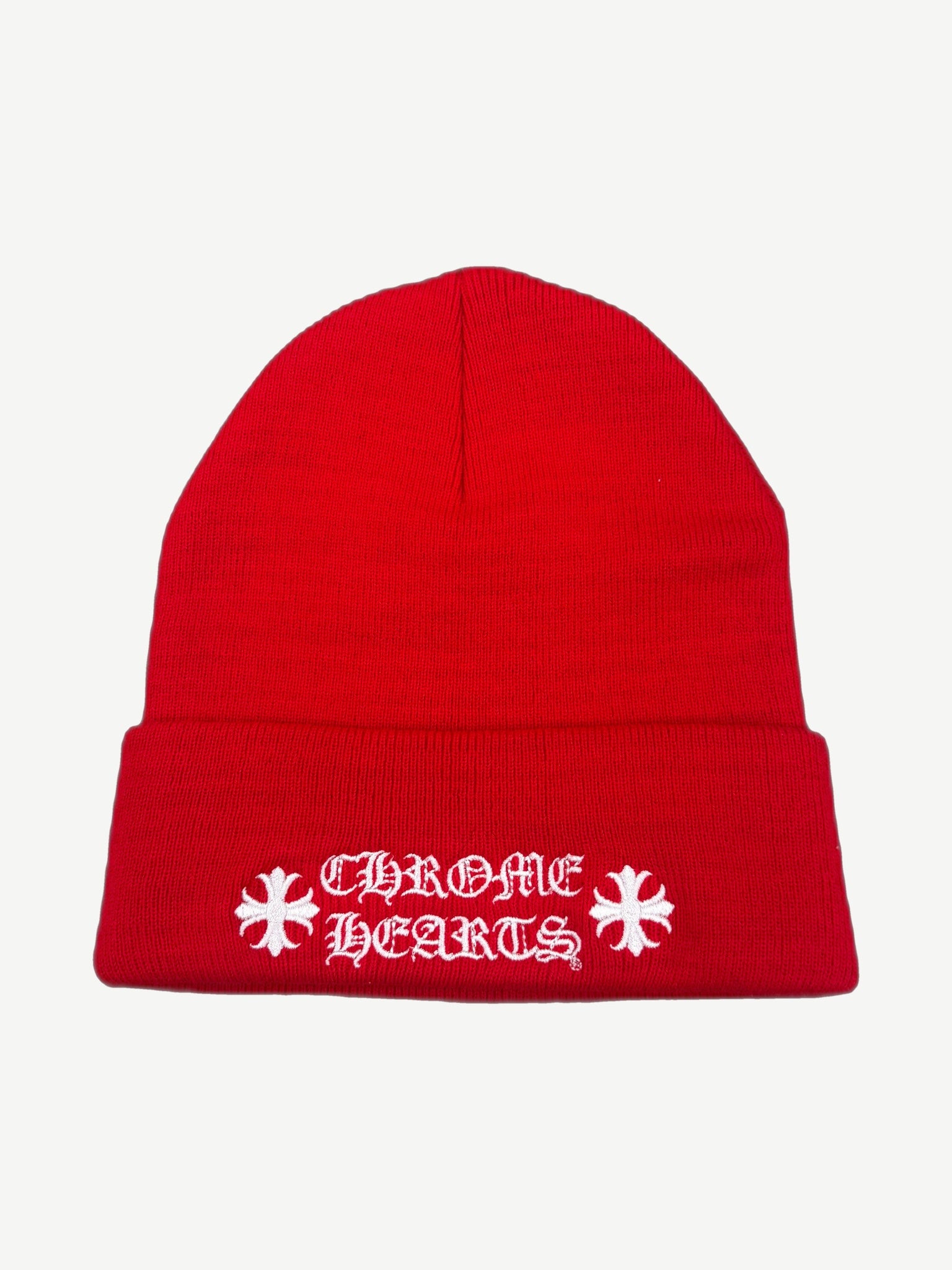 Chrome Hearts red knit beanie with white gothic Chrome Hearts wordmark and embroidered cross logos.