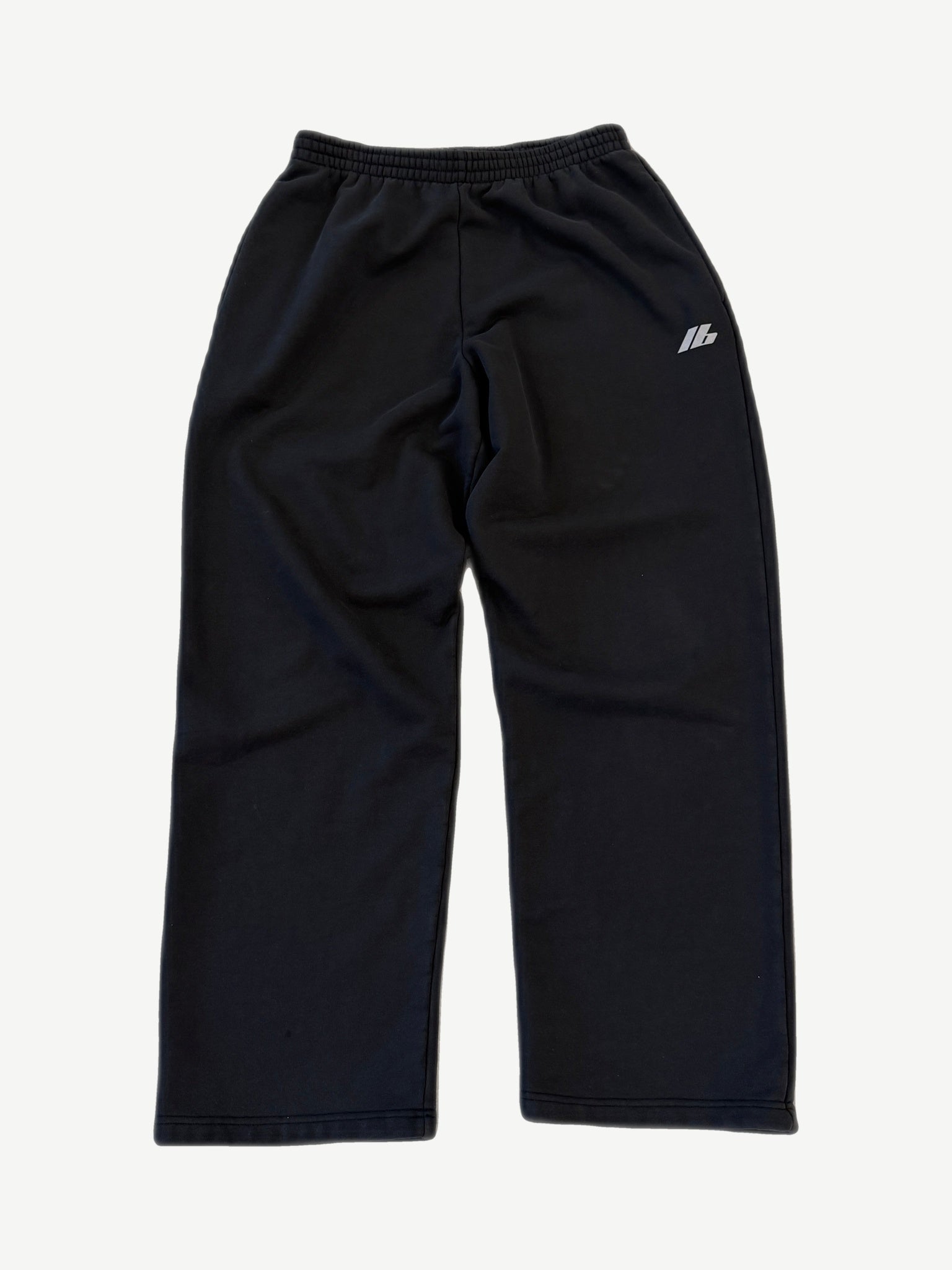 Balenciaga 3M logo sweatpants in black with reflective silver Balenciaga wordmark on left thigh.