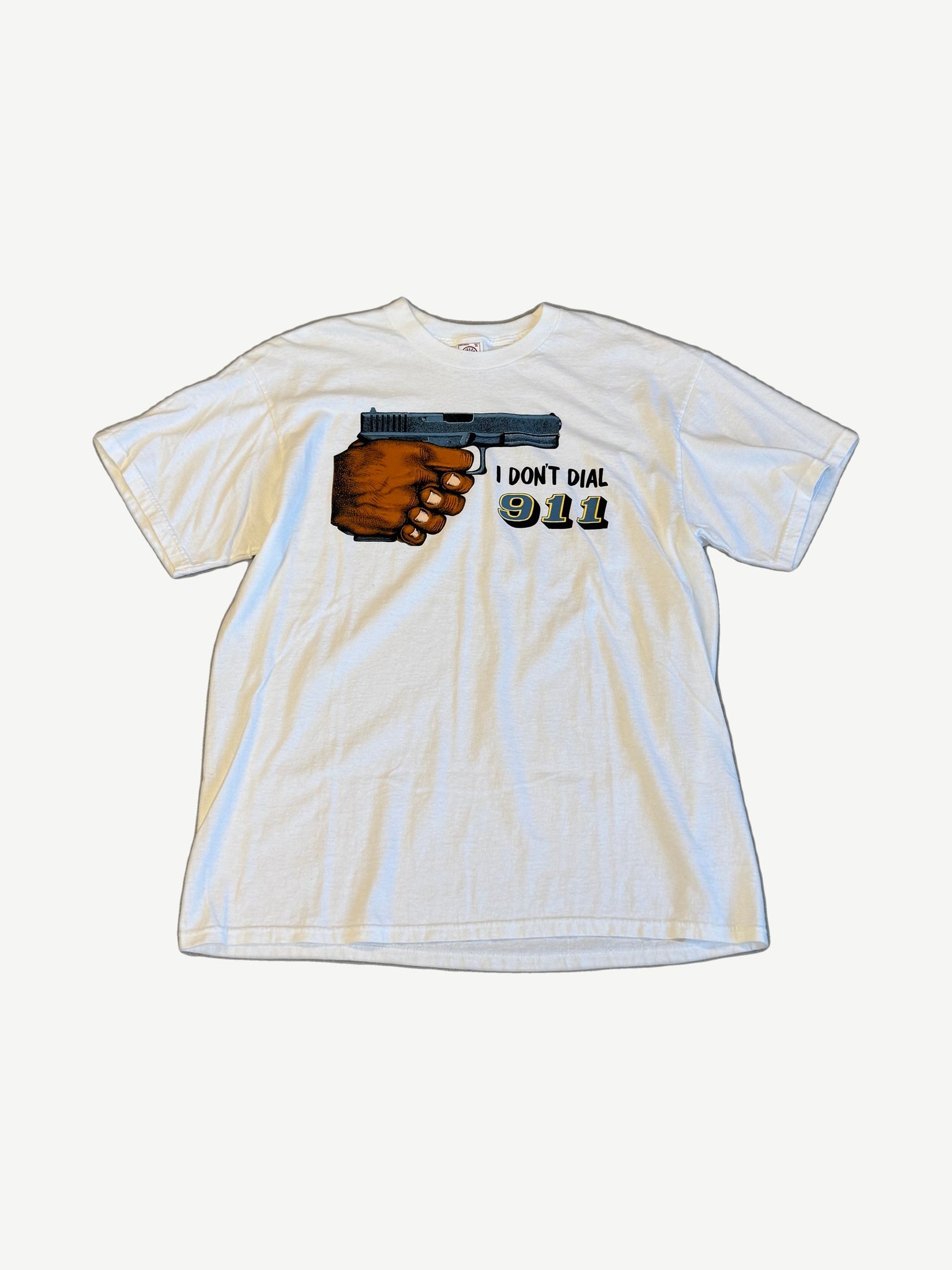 Vintage I Don't Dial 911 white tee with graphic of hand holding pistol and 911 text
