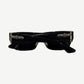 Chrome Hearts Yer Born Again sunglasses side angle showing silver cross dagger hinge hardware on black temple.