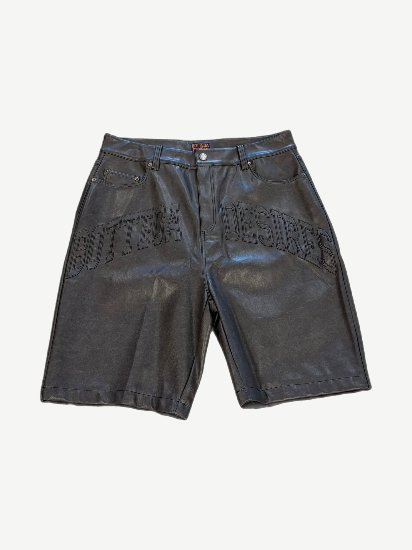 Bottega Desires black leather shorts front with tonal Bottega Desires varsity arch logo across thighs