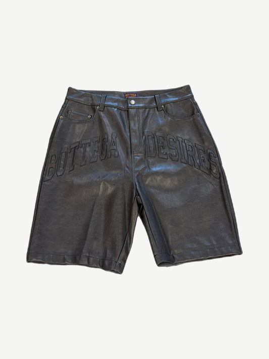 Bottega Desires black leather shorts front with tonal Bottega Desires varsity arch logo across thighs