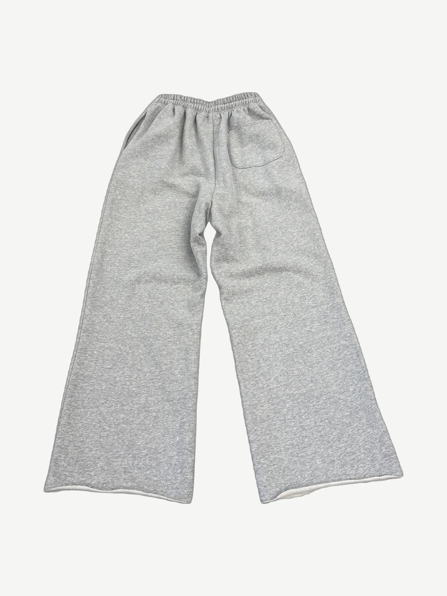 Happy Memories Don't Die gray sweatpants back view showing studded HMDD lettering and circular badges.