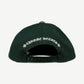 Chrome Hearts green cotton dad hat, top angle view of curved brim and white stitched CH logo