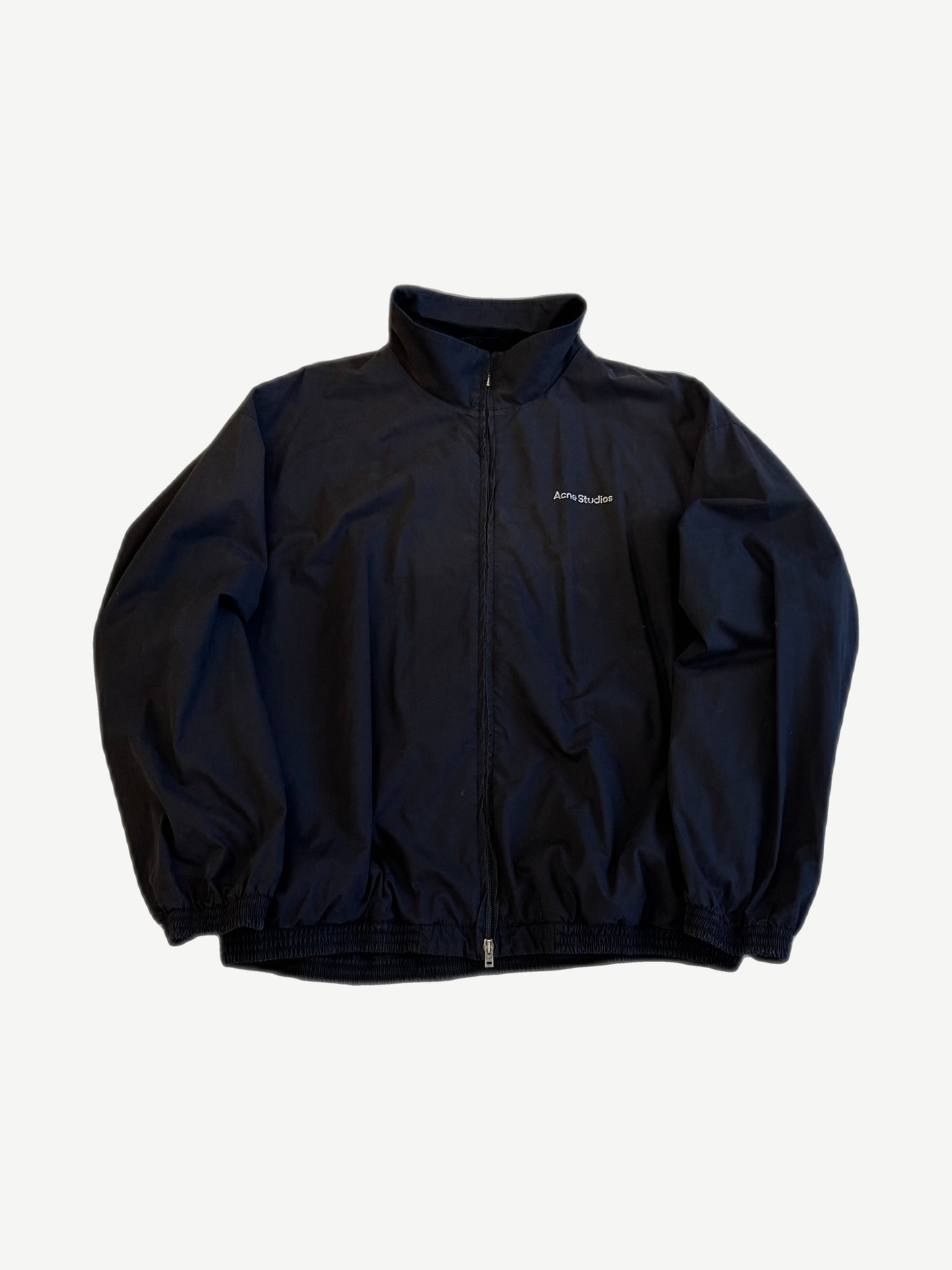 Acne Studios vintage navy nylon track jacket with washed white chest logo, stand collar and full zip front