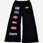 Bottega Desires black flared sweatpants with multiple racing-style brand patches down the left leg