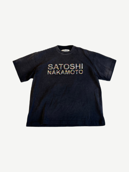 Satoshi Nakamoto faded black tee with rhinestone-jeweled SATOSHI NAKAMOTO chest text on washed cotton.