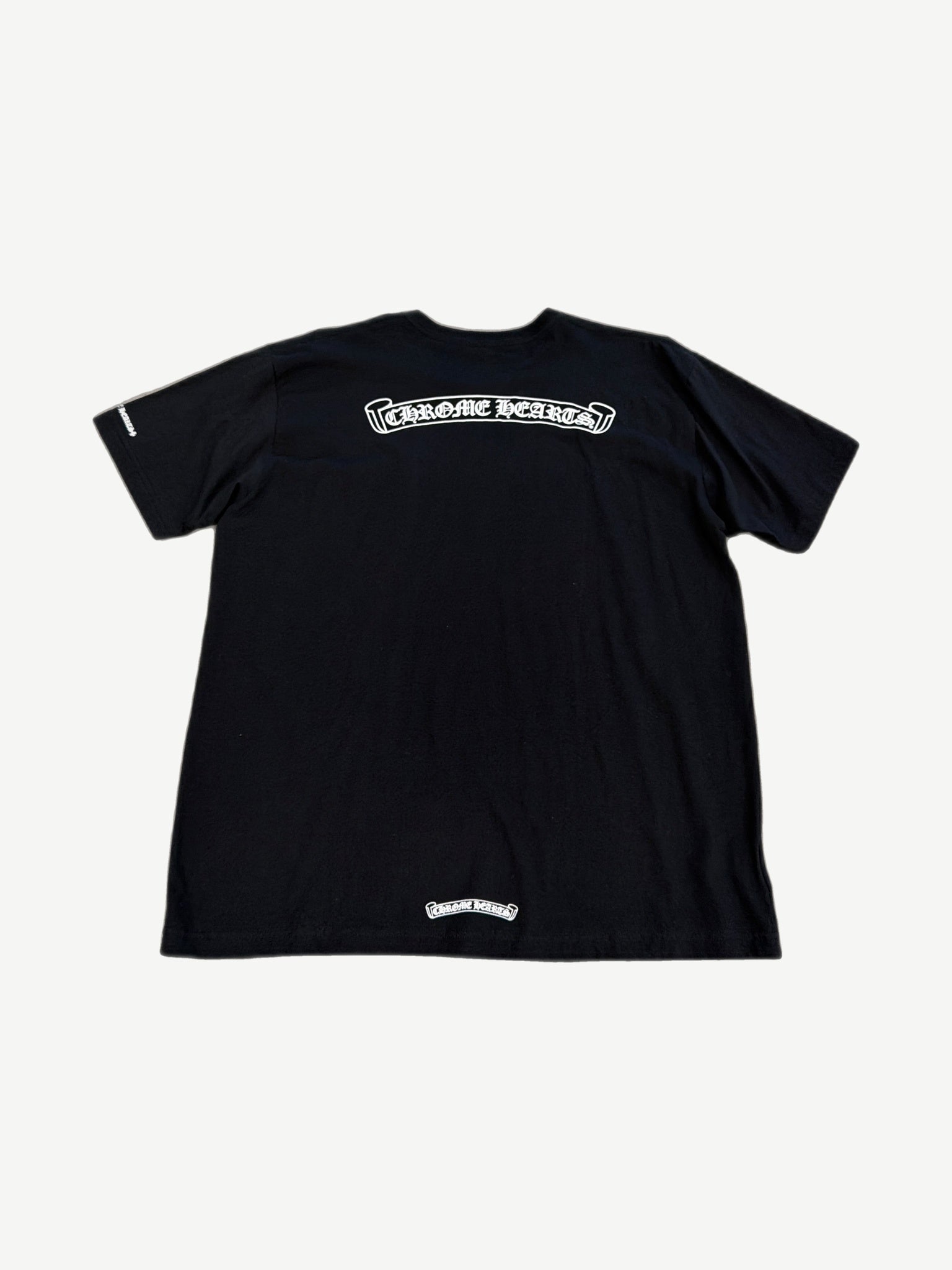 Back of Chrome Hearts black tee with large white Old English Chrome Hearts scroll print across shoulders