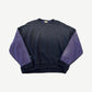 Kapital two-tone crewneck sweatshirt front in faded black body with contrasting purple sleeves and ribbed hem