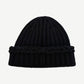 Chanel black ribbed cashmere beanie shown from side with subtle sequin texture and folded knit cuff.