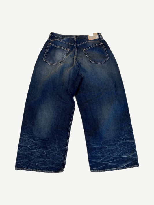 Back of Acne Studios baggy mid blue 2023M jeans showing faded seat, rear patch pockets and wide leg.