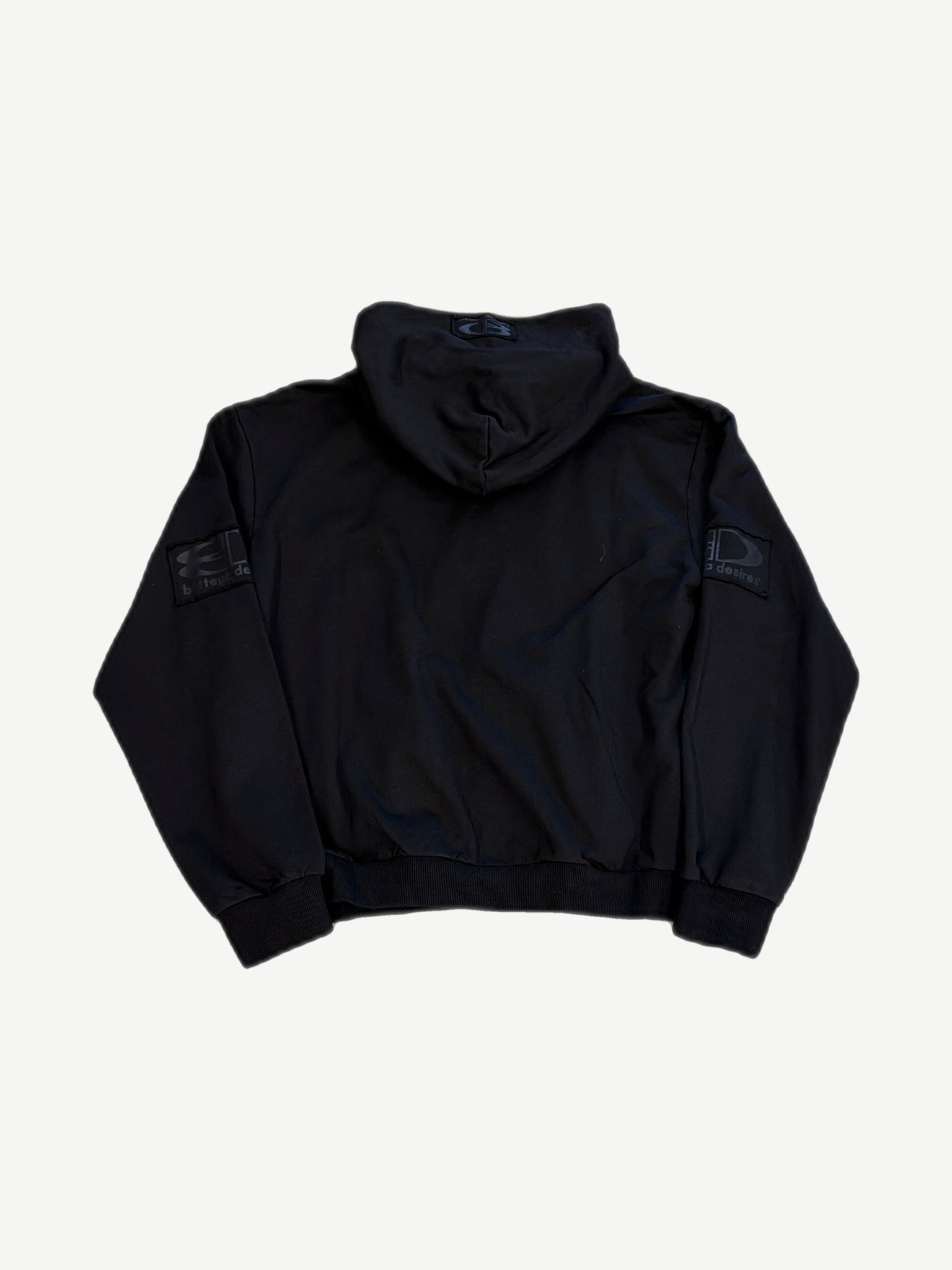 Back view of Bottega Desires black tech zip-up showing clean back panel and tonal sleeve logo patches