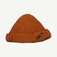 Paly Hollywood hand-knit chunky ribbed beanie in burnt orange with navy PALY logo embroidered on cuff.