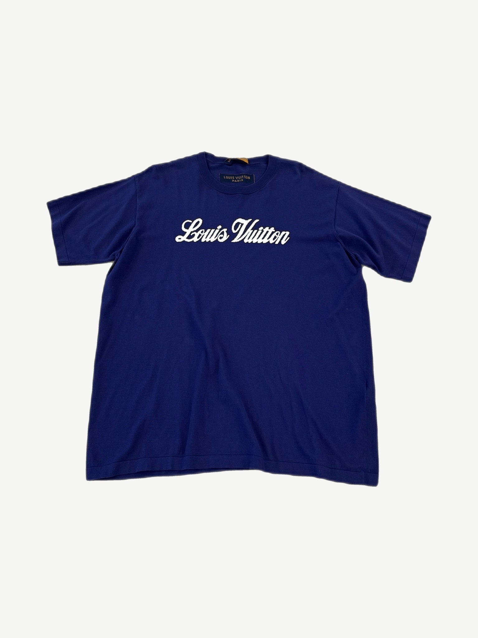 Louis Vuitton royal blue tee front with white cursive Louis Vuitton signature script logo across chest.