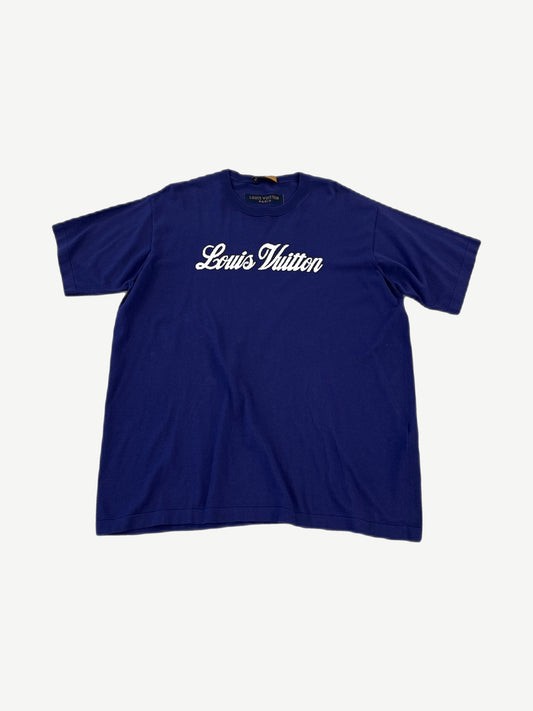 Louis Vuitton royal blue tee front with white cursive Louis Vuitton signature script logo across chest.