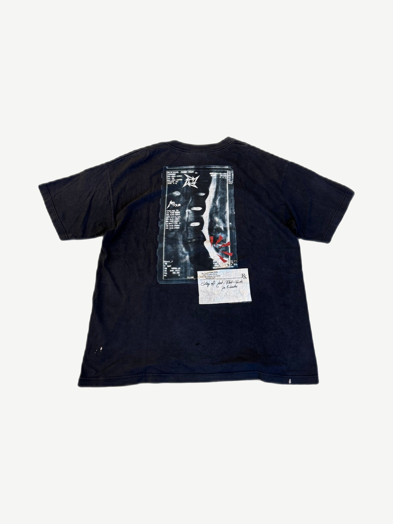 Back of vintage Metallica MRI Tour tee with spine x-ray print and 2000 tour date list across the back
