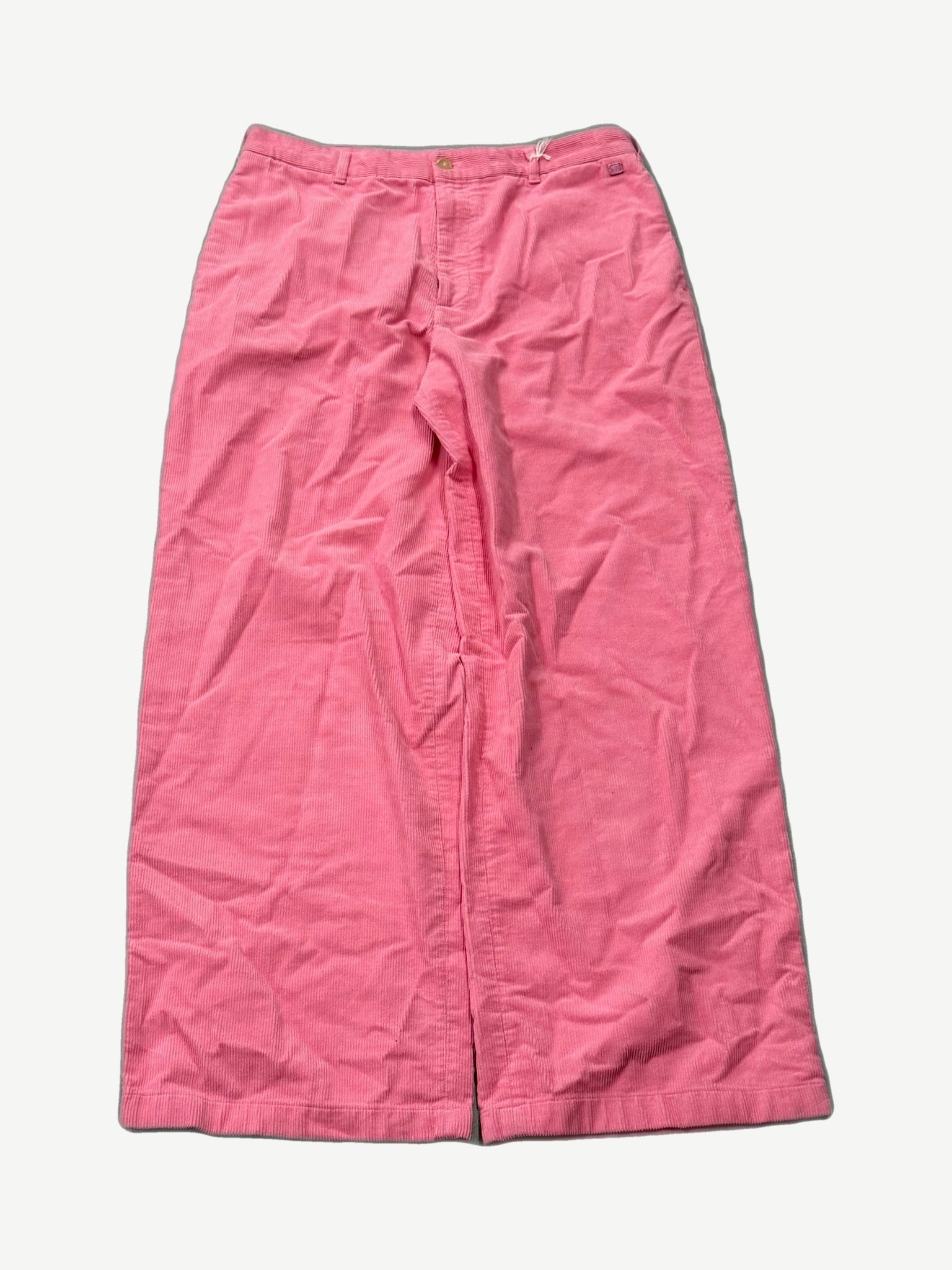 Acne Studios Tango pink corduroy wide-leg pants front view with button fly and contrast white waistband stitching