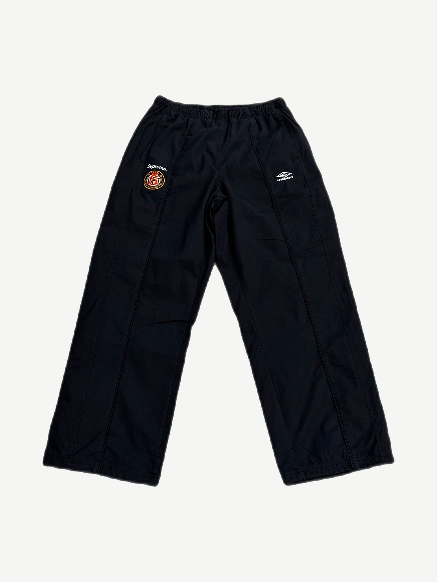 Supreme x Umbro black cotton ripstop track pants with Supreme World Famous patch and Umbro diamond logo.