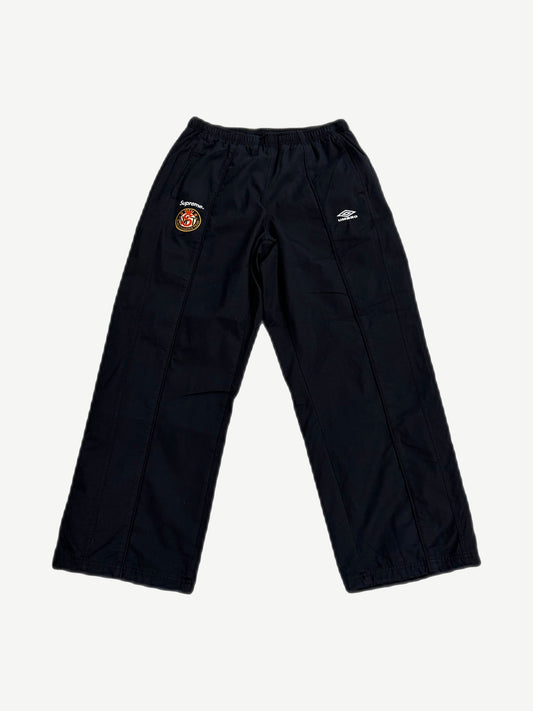 Supreme x Umbro black cotton ripstop track pants with Supreme World Famous patch and Umbro diamond logo.