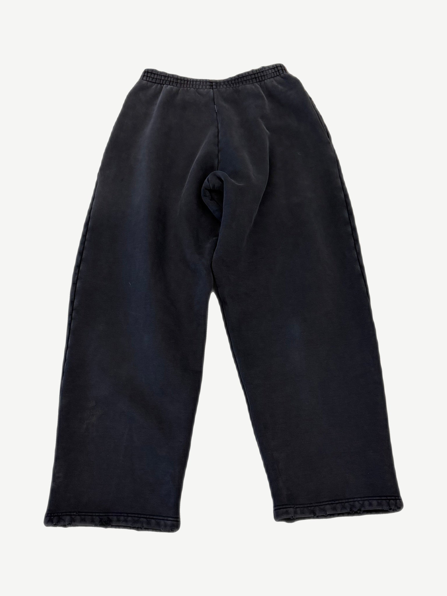Back of Balenciaga washed black sweatpants with elastic waistband and faded sun-washed cotton fleece finish
