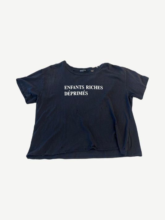 Enfants Riches Deprimes black distressed tee front with white block logo across chest and scattered pinholes.