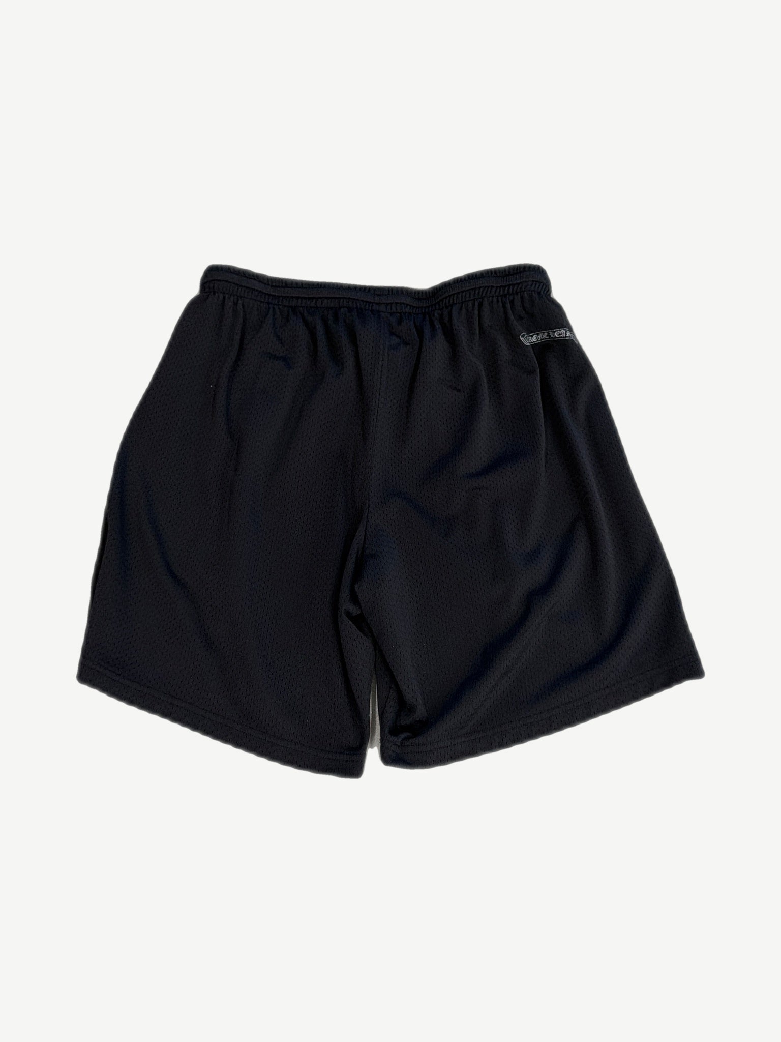 Chrome Hearts black mesh shorts back view with white Chrome Hearts gothic scroll patch on rear waistband.