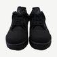 Front view of Air Jordan 4 Black Cat 2025 with reflective Jumpman tongue tag and triple-black nubuck upper