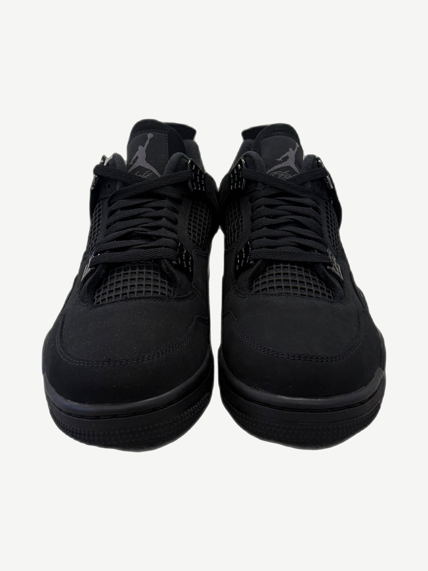 Front view of Air Jordan 4 Black Cat 2025 with reflective Jumpman tongue tag and triple-black nubuck upper