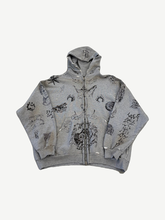 Balenciaga gray oversized zip-up hoodie covered in all-over black tattoo flash prints of script, faces and symbols