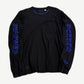 Chrome Hearts black longsleeve tee with cobalt blue gothic CHROME HEARTS print on both sleeves and neck cross logo.