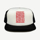 Chrome Hearts black trucker hat front with red and white eyechart text panel and white mesh side panels.