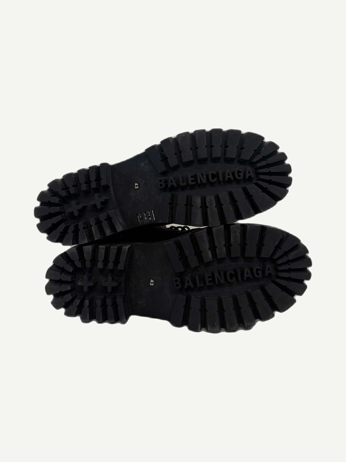 Balenciaga Combat Strike boot sole detail showing aggressive deep lug tread with debossed BALENCIAGA branding.