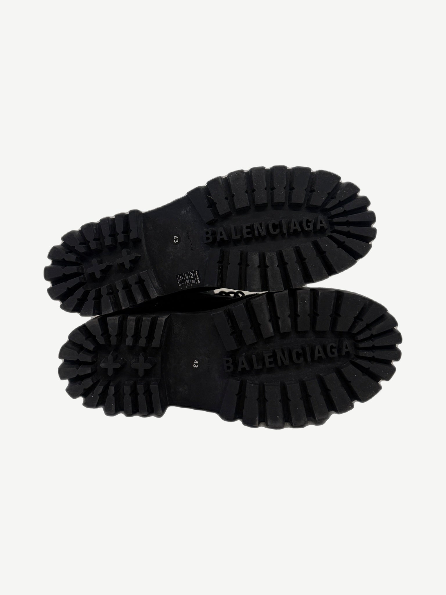Balenciaga Combat Strike boot sole detail showing aggressive deep lug tread with debossed BALENCIAGA branding.
