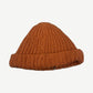 Paly Hollywood orange hand-knit logo beanie rear view showing thick ribbed knit texture and folded cuff.