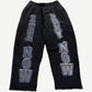 Balenciaga washed black sweatpants with large See Now Buy Now silver and purple block letter print on legs