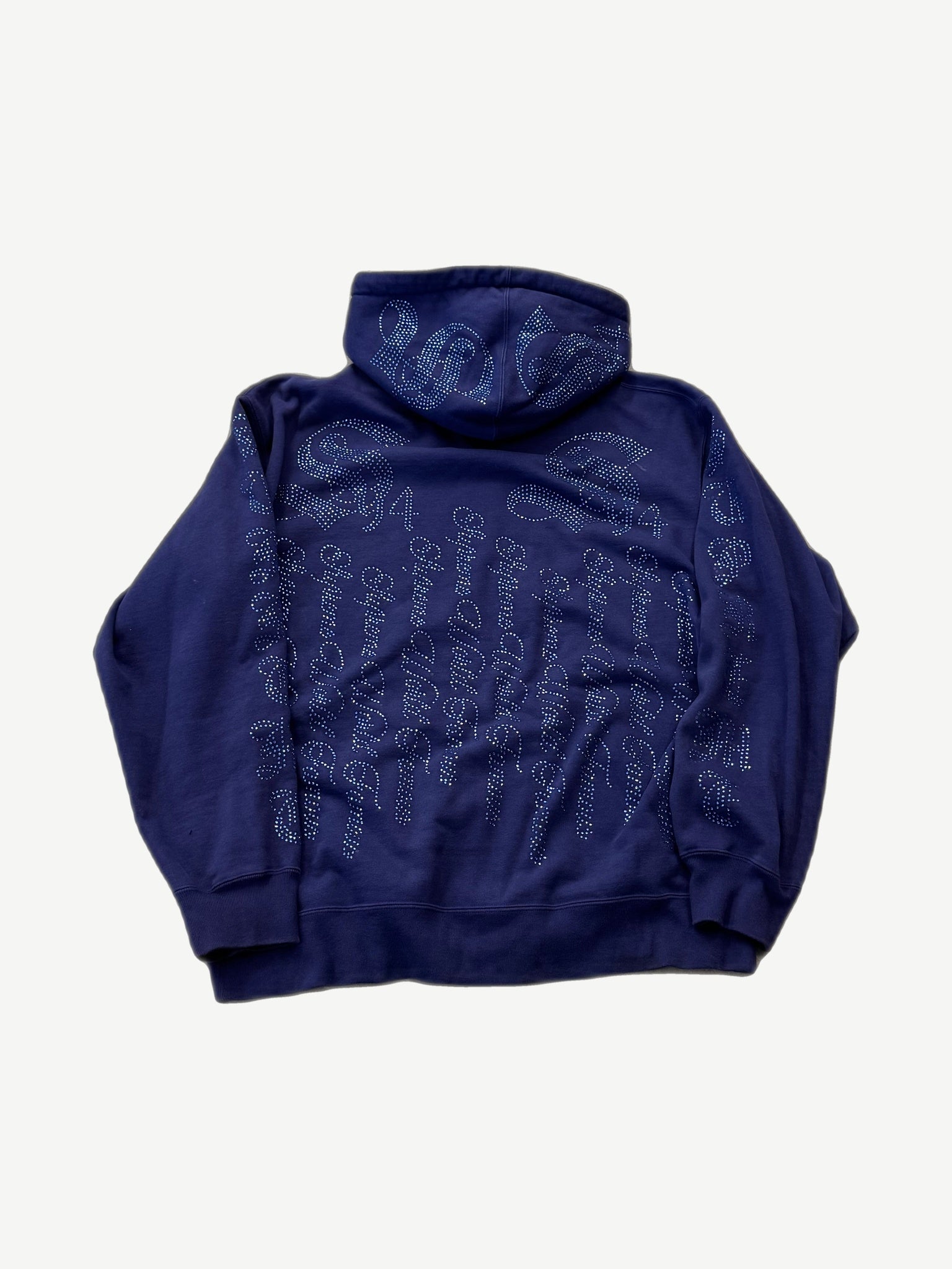 Supreme washed navy rhinestone zipup hoodie back view with repeating crystal script logo across body and hood