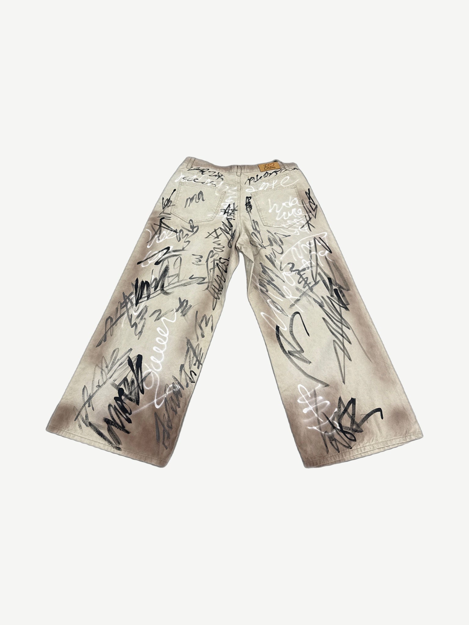 HMDD tan graffiti print wide-leg chino pants back view showing baggy fit and waistband detail