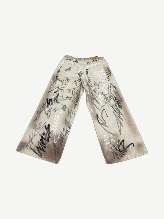 HMDD tan graffiti print wide-leg chino pants back view showing baggy fit and waistband detail