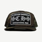 Chrome Hearts camo trucker hat with CHROME HEARTS CH HOLLYWOOD USA patch and curved camouflage bill.