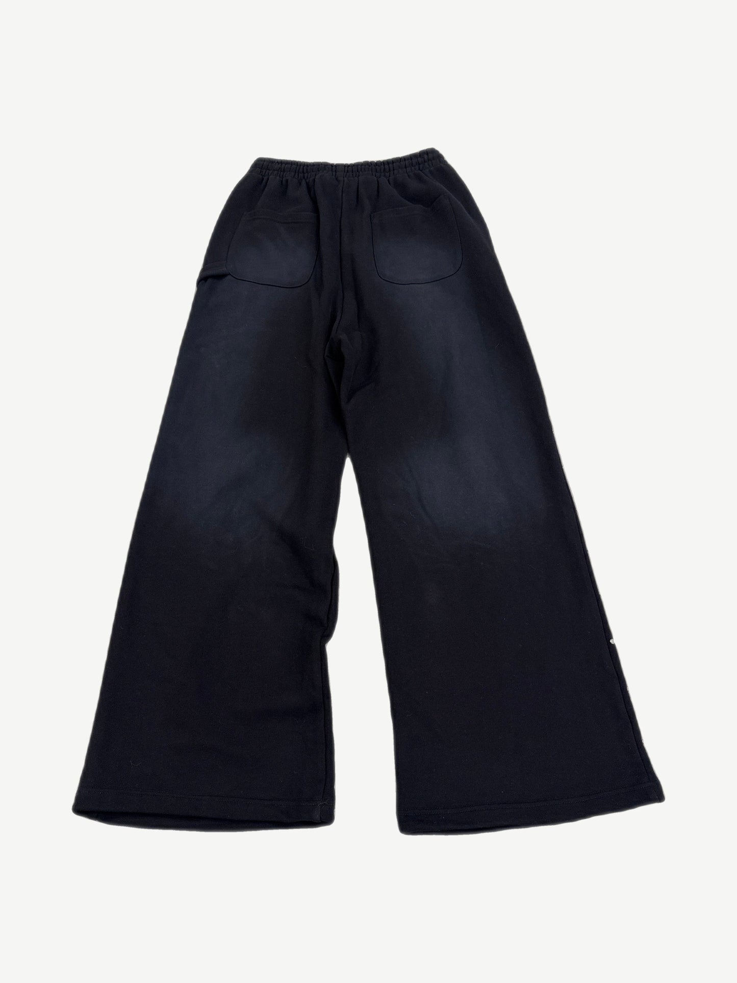 Back view of HMDD black flared sweatpants with patch pockets and faded fabric finish
